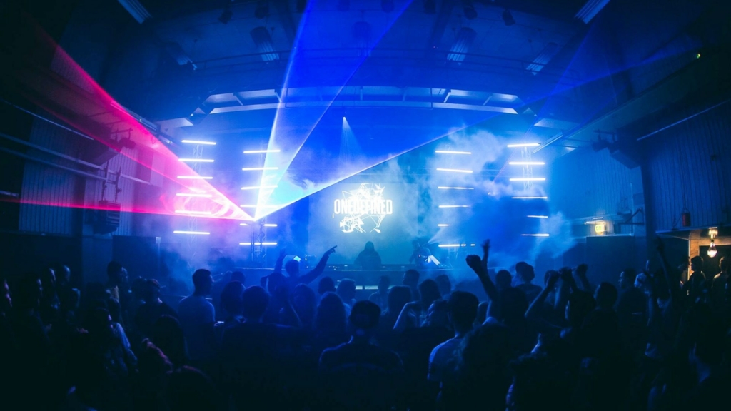 A euphoric crowd dances under flashing strobe lights of ONEDEFINED during a Fack It Club Night in Smederij, Tilburg.